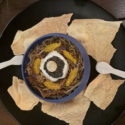 Caviar with crispy leeks, cured egg yolk, and crème fraiche Caviar with crispy leeks, cured egg yolk, and crème fraiche