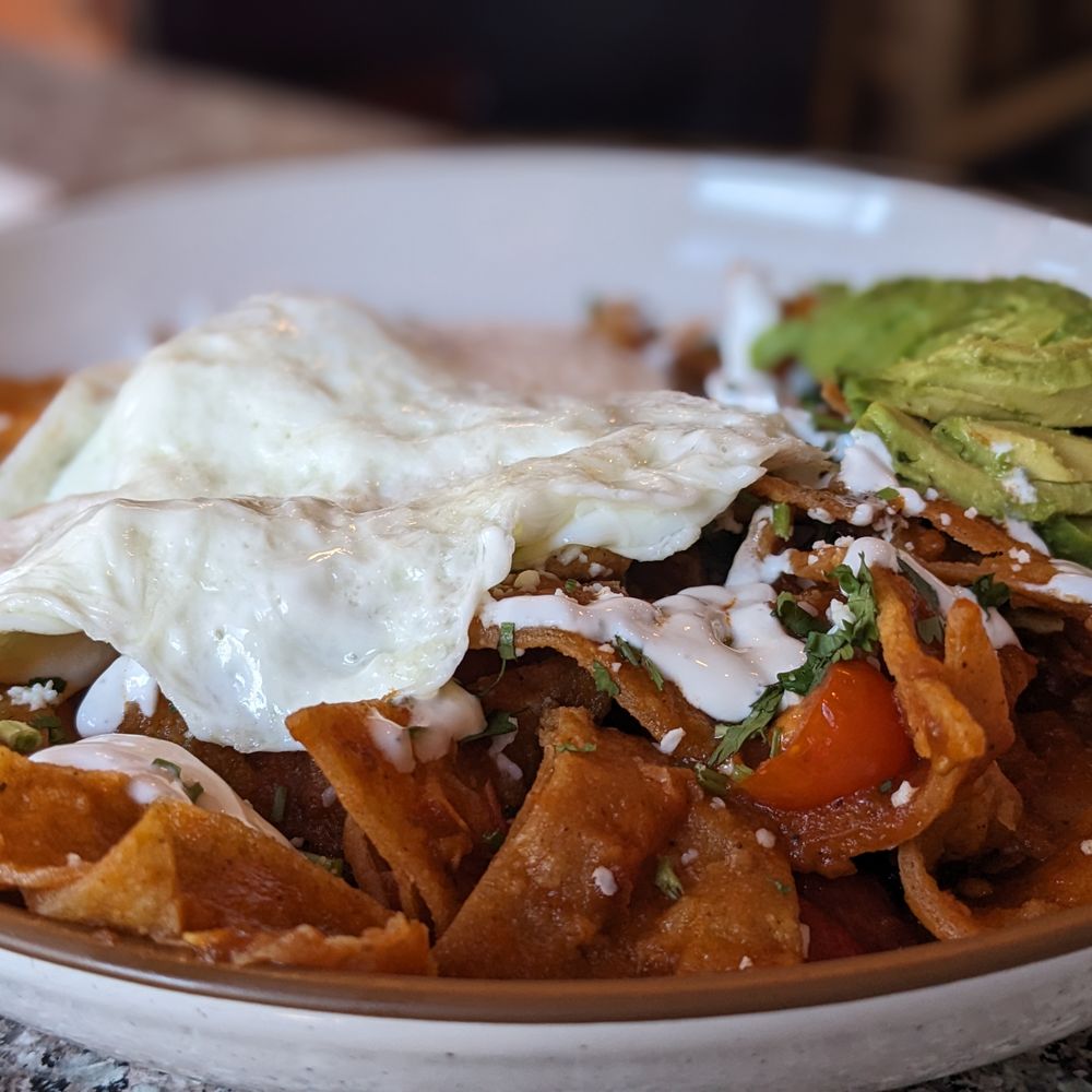 Paula's Cafe - Chilaquiles Rancheros with add on: Carnitas (hidden under eggs). - Breakfast & Brunch Near Me - San Francisco, California Paula's Cafe - Chilaquiles Rancheros with add on: Carnitas (hidden under eggs). - Breakfast & Brunch Near Me - San Francisco, California