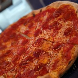 a pepperoni pizza on a table a pepperoni pizza on a table
