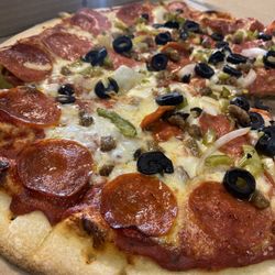 Pizza King-Richland - Combination pizza with pepperoni, sausage, black olives, green bell peppers and onions