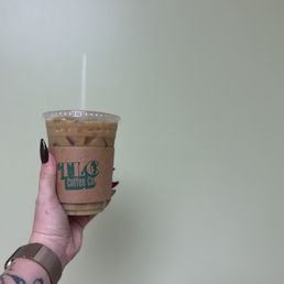 a hand holding a cup of coffee a hand holding a cup of coffee