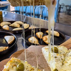 Hot & fresh signature Fugazzeta pizza.