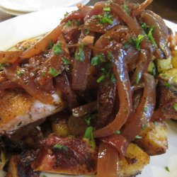 Canggio Restaurant - The grilled salmon topped w/ tart vinegar based onion sauce and served with grilled red potatoes spiced with panca pepper & season veggies.