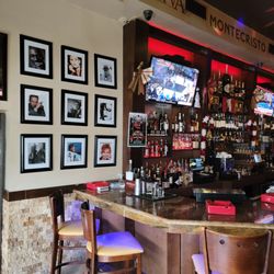 Cigar Republic USA - Check out our iconic wall showcasing legendary stars enjoying cigar!