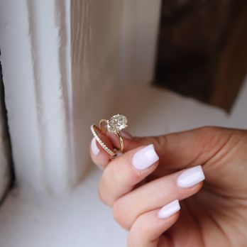Fink's Jewelers - Oval diamond engagement ring paired perfectly with a simple diamond eternity band. - Jewelry Near Me - Durham, North Carolina