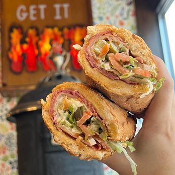 Potbelly - a hand holding a sandwich - Sandwiches Near Me - Maple Grove, Minnesota Potbelly - a hand holding a sandwich - Sandwiches Near Me - Maple Grove, Minnesota
