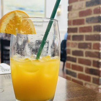 M Restaurant - a glass of orange juice on a table - Italian Near Me - Avalon, California M Restaurant - a glass of orange juice on a table - Italian Near Me - Avalon, California
