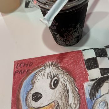 Monty's Good Burger - Cola with straw and the art on the table - Burgers Near Me - Los Angeles, California