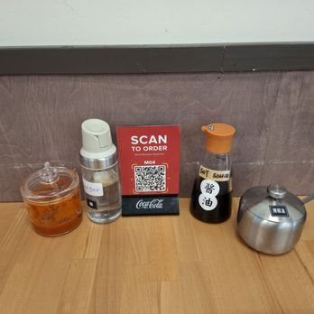 Aloha Manapua - Condiments including vinegar and their house chili oil (in the stainless steel container) - Dim Sum Near Me - Honolulu, Hawaii