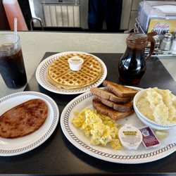 Waffle House - All American Breakfast - Ham , Scrambled Eggs , Grits , Toast , and of course Waffle with a Mr Pibb.