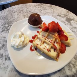 Strawberry delight waffle with a scoop of dark chocolate sorbet.