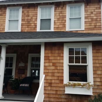 Doherty Customs - the front of a house with a porch - Roofing Near Me