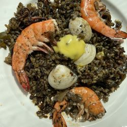 Paella Negra, squid ink with prawn, octopus, white wine and calamari.