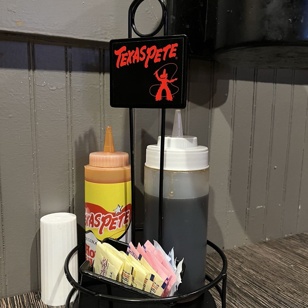 Kiki's Chicken and Waffles - Texas Pete and syrup on every table. - American Near Me - Columbia, South Carolina