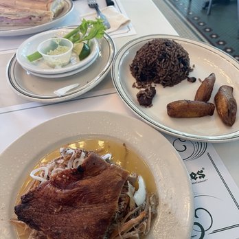 Versailles - Pork and sides, Cuban Baguette Sandwich in the rear - Cuban Near Me - Miami, Florida Versailles - Pork and sides, Cuban Baguette Sandwich in the rear - Cuban Near Me - Miami, Florida