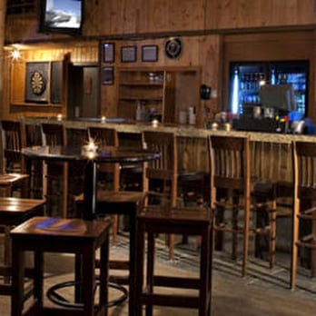 Woody's Pub & Patio - a bar with wooden tables and stools - Pubs Near Me - Kananaskis, Alberta Woody's Pub & Patio - a bar with wooden tables and stools - Pubs Near Me - Kananaskis, Alberta