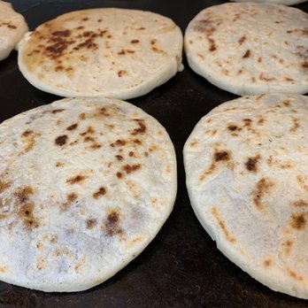 Guana Cafe - six flatbreads cooking on a grill - Salvadoran Near Me - Irving, Texas Guana Cafe - six flatbreads cooking on a grill - Salvadoran Near Me - Irving, Texas