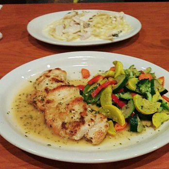 Cannataro's - Plate upfront: lemon herb chicken. Plate in the background: chicken Alfredo. - Italian Near Me - Chino, California Cannataro's - Plate upfront: lemon herb chicken. Plate in the background: chicken Alfredo. - Italian Near Me - Chino, California