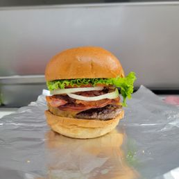 a hamburger with lettuce, tomato, and cheese a hamburger with lettuce, tomato, and cheese