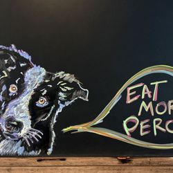 Our dog - Obie featured here on our daily feature chalkboard in the entryway. Obie is also featured on our house hot sauce & on our menu.