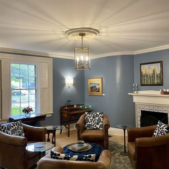 OneSixtyFive - a living room with blue walls - Hotels Near Me - Brunswick, Maine