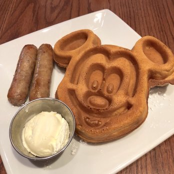 Carnation Cafe - Mickey Mouse Waffles. Other side had powdered sugar, just flipped it over for the picture. Cute but way too crispy for my liking. - American Near Me - Anaheim, California