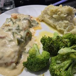 Salmon with seafood chowder, mashed potatoes and a side broccoli