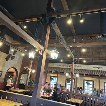 Jalapenos - Incredible dining room - A Mexican restaurant interior featuring wooden beams, hanging lanterns, and a rustic design with multiple tables and patrons dining. - Mexican Near Me - Schereville, Indiana