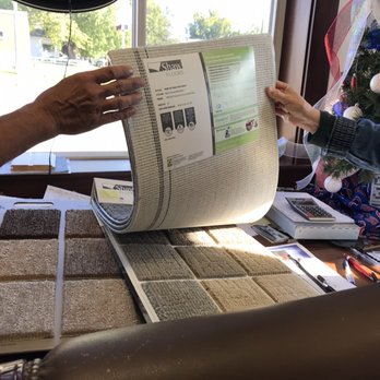 Till's Flooring & Carpentry - a man and woman looking at carpet samples - Flooring Near Me - Maquoketa, Iowa