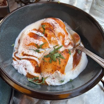 Yayla Bistro - CHILBIR CHILBIR - Turkish style poached eggs topped with creamy garlic yogurt, sumac, and tomato sauce. - Mediterranean Near Me - Arlington, Virginia Yayla Bistro - CHILBIR CHILBIR - Turkish style poached eggs topped with creamy garlic yogurt, sumac, and tomato sauce. - Mediterranean Near Me - Arlington, Virginia