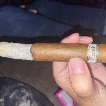 The Cigar Vault East - a hand holding a cigar - Tobacco Shops Near Me - Austin, Texas The Cigar Vault East - a hand holding a cigar - Tobacco Shops Near Me - Austin, Texas