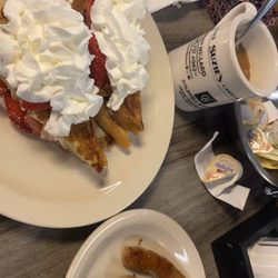 Suzies Lakeland Diner - Cream cheese and strawberry stuffed French toast with whipped cream, and sausage links.