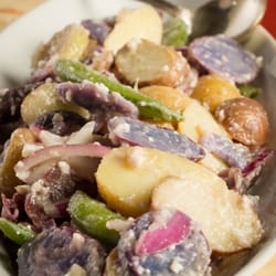 Elegant Events & Custom Catering - Baby tri-colored potatoes in a garlic lemon sauce sprinkled with pecorino romano cheese