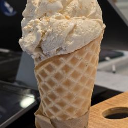 Blue Cow Ice Cream - A Waffle Cone with a scoop of Banana Pudding Ice Cream.