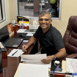 Comprehensive Orthopedic Physical Therapy - Gopal Patel in his office looking over patient documents.