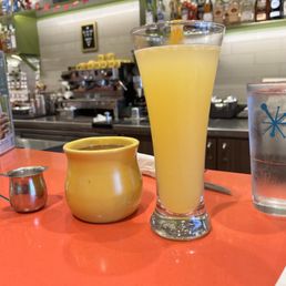 Bar seated with a water, mimosa, and Americano.