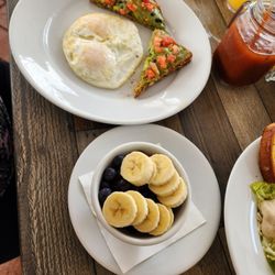 Protein Avocado Toast with Eggs and a fruit bowl