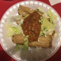 Tamales with lettuce, hot red salsa, and creamy green salsa