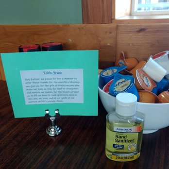 Wayne's Corner Cafe - Table Grace on every table along with sanitizer, mixed creamers and salt and pepper grinders. - American Near Me - Stanwood, Washington