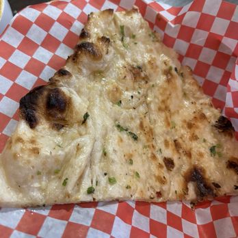 Inchin's Indian Kitchen - Garlic Naan (3 pieces were already eaten when this photo was taken) - Indian Near Me - Niagara Falls, Ontario Inchin's Indian Kitchen - Garlic Naan (3 pieces were already eaten when this photo was taken) - Indian Near Me - Niagara Falls, Ontario