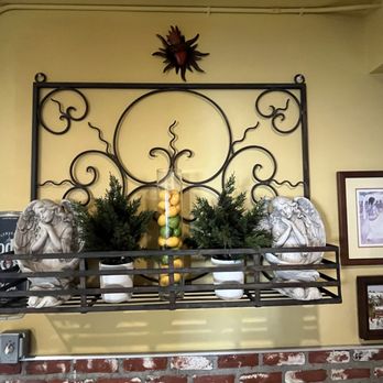Tere's Mexican Grill - Statues of angels with fake plants, random pictures, and also a vase filled with fake citrus. - Mexican Near Me - Los Angeles, California Tere's Mexican Grill - Statues of angels with fake plants, random pictures, and also a vase filled with fake citrus. - Mexican Near Me - Los Angeles, California