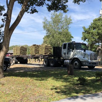 Upzide Down Sod - a truck hauling a load of wood - Landscaping Near Me Upzide Down Sod - a truck hauling a load of wood - Landscaping Near Me