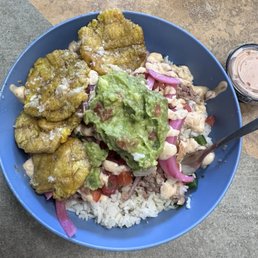 Cilantro lime rice, pernil, pickled red onion and guacamole with tostones/patacones(PTY). Super Deli!