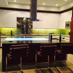 Tamara Dattilo Design - Modern and edgy kitchen featuring dark Cesar stone counters contrasted by a glass LED-lit inlay and lime back splash energize this space.
