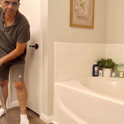 Corporate Cleaning Services - Bathroom floor being mopped.