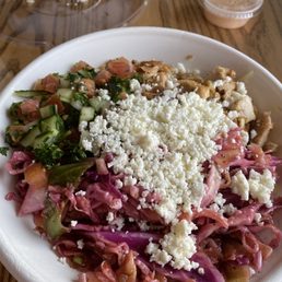 Chicken bowl with, rice, feta cheese, slaw, cucumber salad. Delicious