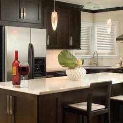 Urban Remodelers - Espresso Shaker-style cabinetry. Very classy look with light quartz counter-tops.