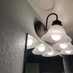 Vanity light looked like it was falling off the wall.