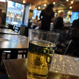 a glass of beer on a table a glass of beer on a table
