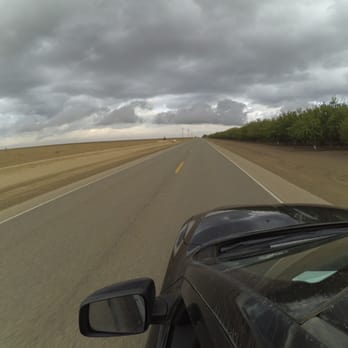City Of Kerman - driving action shot along orchard-lined highway - Public Services & Government Near Me